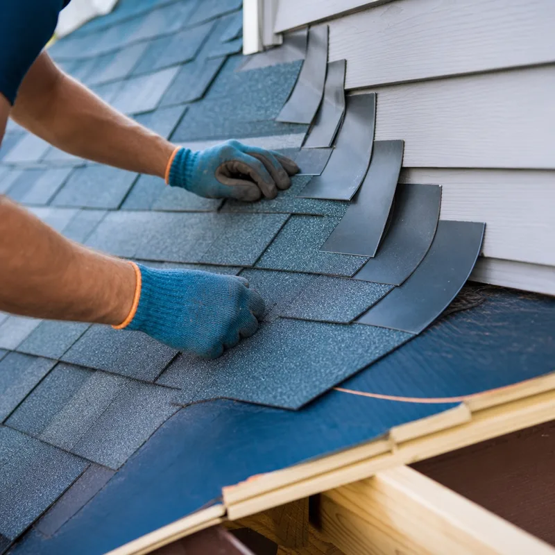 Close view of properly installed step flashing and ice-and-water shield during a Grand Rapids roofing project
