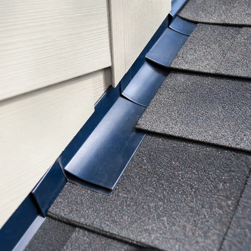 Properly installed step flashing and counterflashing at a residential sidewall intersection
